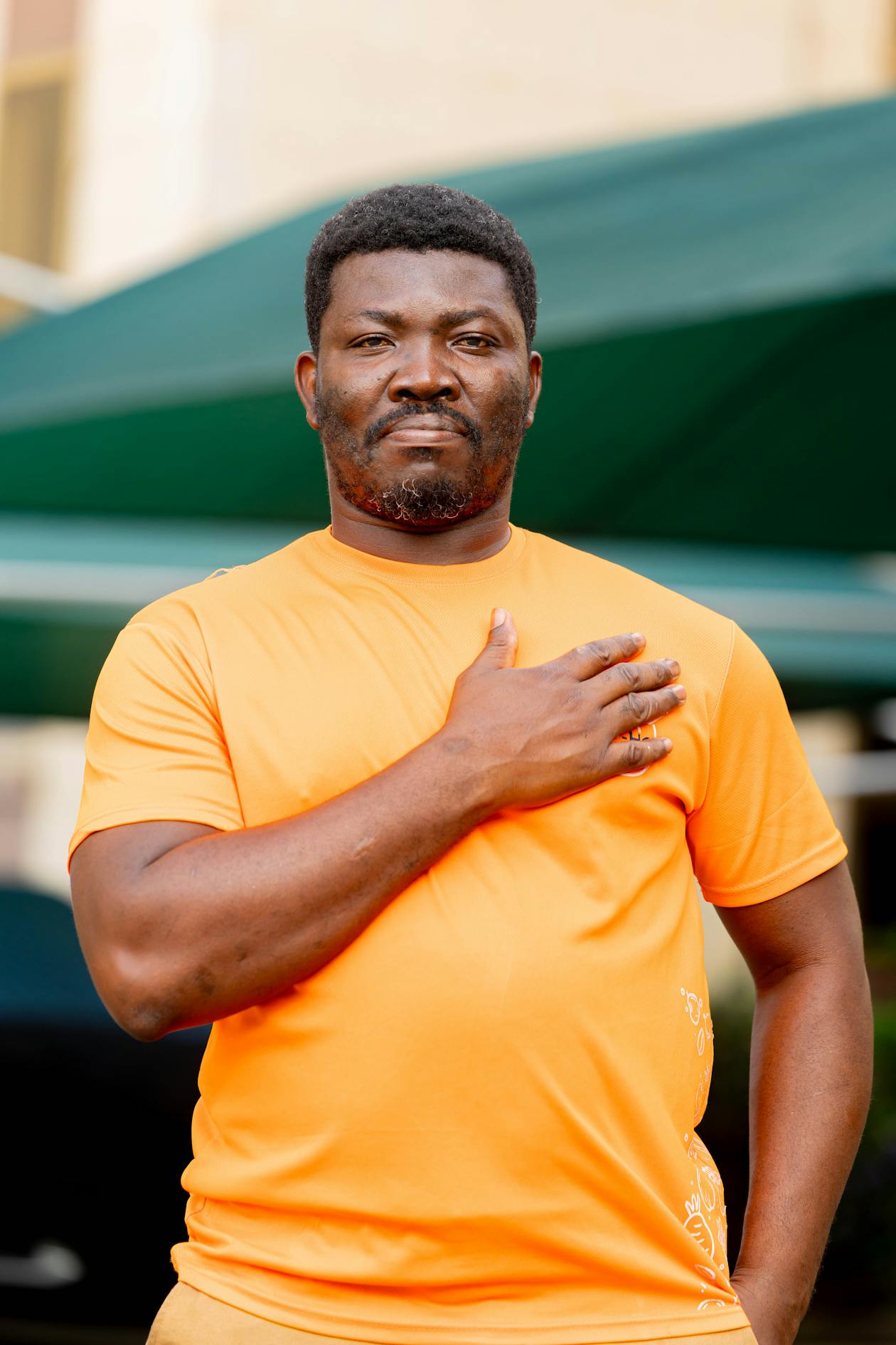 Man in orange tshirt outdoors casual