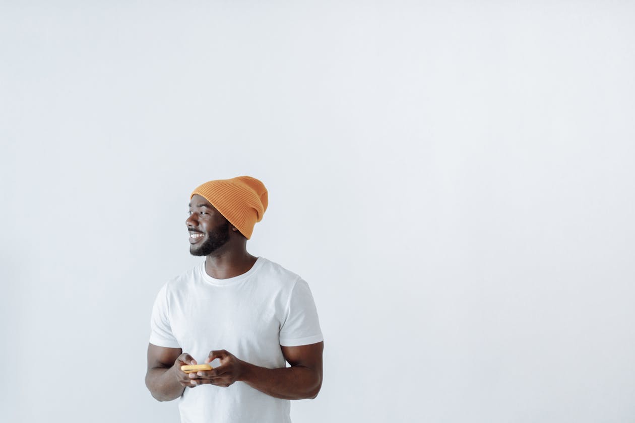Smiling man in beanie casual orange